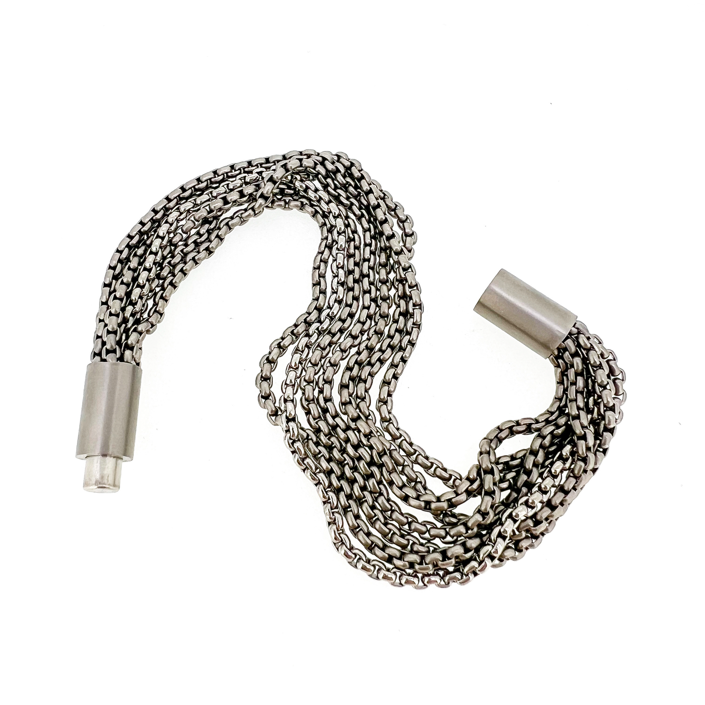 Titanium bracelet made of 7 titanium chains - 6 sandblasted and one polished with sandblasted titanium magnetic lock. Diameter 9mm. Made and designed by Zeezen.