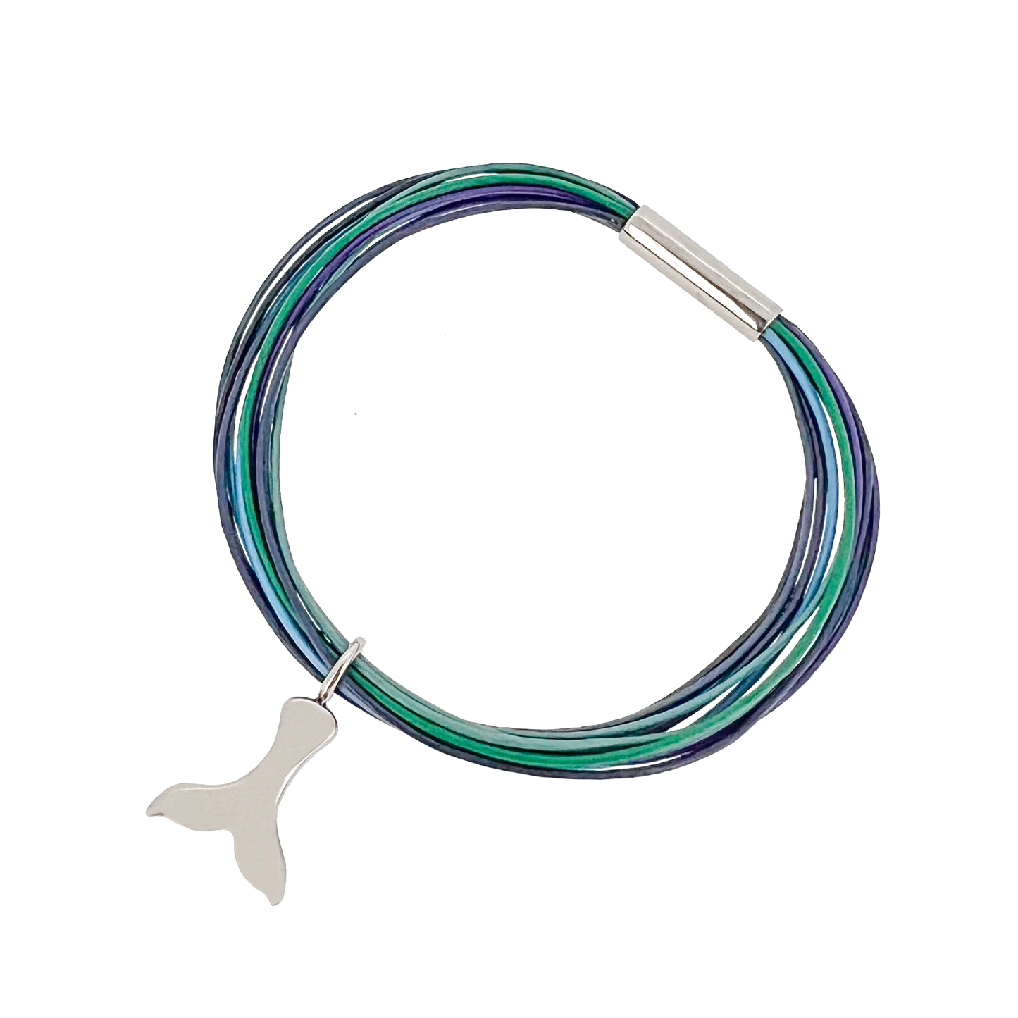 Northern Lights Bracelet, leather bracelet with whale tail charm. The bracelet has 25 X 0.5mm leather strings and 6mm titanium magnetic lock. This exquisite piece, is designed by Bolli Ófeigssson master goldsmith and meticulously crafted by Zeezen, draws inspiration from the enchanting allure of Iceland's aurora borealis